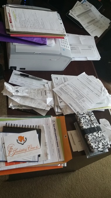 Organizing Paperwork in a Home Office - sorting paper into piles to file
