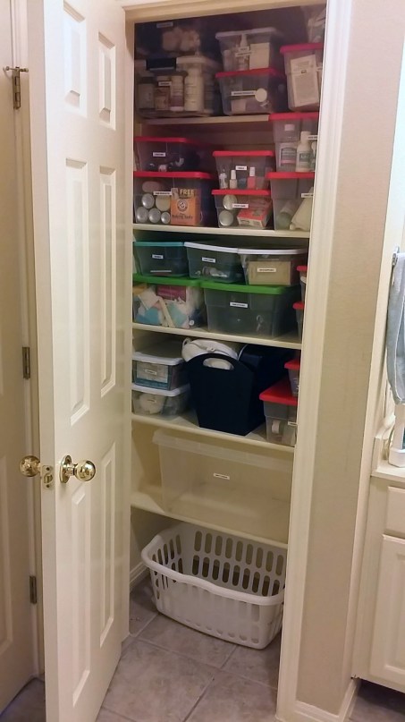 Organizing and Containing Bathroom Closet Items - Organized Bathroom Closet Full
